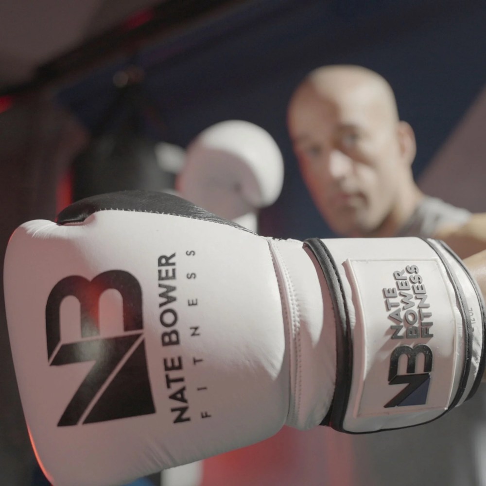 Nate Bower Fitness Elite Punching Bag Boxing Gloves - Extra Thick Padding for Unisex Beginner Boxers and Training Fitness - Premium Cowhide Leather -Black Boxing Gloves with White Accents - 10oz - Image 4